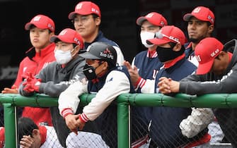 SK Wyverns players wearing face masks watch the game from the dugout during the opening game against Hanwha Eagles for South Korea's new baseball season at Munhak Baseball Stadium in Incheon on May 5, 2020. - South Korea's professional sport returned to action on May 5 after the coronavirus shutdown with the opening of a new baseball season, while football and golf will soon follow suit in a ray of hope for suspended competitions worldwide. (Photo by Jung Yeon-je / AFP) (Photo by JUNG YEON-JE/AFP via Getty Images)