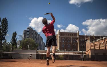 epa08397547 Sportsmen play tennis on a clay court in Vienna, Austria, 02 May 2020. Loosening measures slowing down the ongoing pandemic of the COVID-19 disease, which is caused by the SARS-CoV-2 coronavirus, for hair salons, stores with a shop area over 400 square meters and outdoor sports facilities without physical contact become effective from 02 May onwards after 46 days of restrictions concerning the movement of individuals. A minimum distance of one metre to all persons in public space who do not live in the same household remains, public events with a maximum of ten participants and private meetings are allowed.  EPA/CHRISTIAN BRUNA