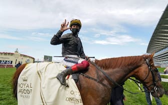 1250483543 ASCOT, ENGLAND - JUNE 18: Frankie Dettori celebrates after riding Stradivarius to win The Gold Cup for the third time in a row on Day Three of Royal Ascot at Ascot Racecourse on June 18, 2020 in Ascot, England. The Queen will miss out on attending Royal Ascot in person for the first time in her 68 year reign. Her Majesty is reported to be planning to watch the racing from home at Windsor Castle, but she will not be able to attend, as the meet goes on behind closed doors due to the Covid-19 pandemic. (Photo by Alan Crowhurst/Getty Images)