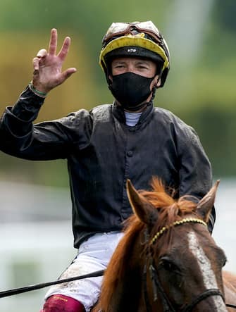 1250478334 ASCOT, ENGLAND - JUNE 18: Frankie Dettori gives the three fingers sign after riding Stradivarius to his third straight win in The Gold Cup on Day Three of Royal Ascot at Ascot Racecourse on June 18, 2020 in Ascot, England. The Queen will miss out on attending Royal Ascot in person for the first time in her 68 year reign. Her Majesty is reported to be planning to watch the racing from home at Windsor Castle, but she will not be able to attend, as the meet goes on behind closed doors due to the Covid-19 pandemic. (Photo by Alan Crowhurst/Getty Images)