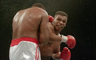 (Original Caption) 1/22/1988-Atlantic City, NJ Ferocious faced Mike Tyson lands the knockout punch to the jaw of challenger Larry Holmes during fourth round of the World Heavyweight Championship.