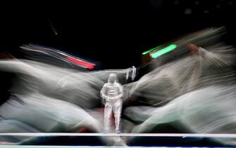 1234140871 TOPSHOT - Italy's Luca Curatoli (L) compete against Romania's Iulian Teodosiu in the men's sabre individual qualifying bout during the Tokyo 2020 Olympic Games at the Makuhari Messe Hall in Chiba City, Chiba Prefecture, Japan, on July 24, 2021. (Photo by Mohd RASFAN / AFP) (Photo by MOHD RASFAN/AFP via Getty Images)
