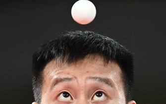 TOPSHOT - Slovakia's Yang Wang competes against Australia's Dave Powell during his men's singles round 2 table tennis match at the Tokyo Metropolitan Gymnasium during the Tokyo 2020 Olympic Games in Tokyo on July 26, 2021. (Photo by Anne-Christine POUJOULAT / AFP) (Photo by ANNE-CHRISTINE POUJOULAT/AFP via Getty Images)