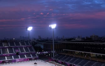 TOPSHOT - A rider attends evening training before the city skyline during the Tokyo 2020 Olympic Games at the Equestrian Park in Tokyo on July 26, 2021. (Photo by Behrouz MEHRI / AFP) (Photo by BEHROUZ MEHRI/AFP via Getty Images)