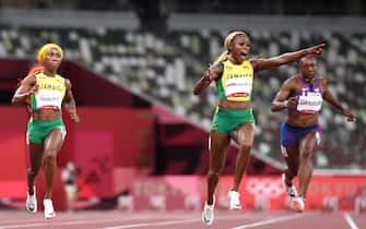 TOPSHOT - Jamaica's Elaine Thompson-Herah (2R) celebrates as she crosses the finish line and wins the women's 100m final next to Jamaica's Shelly-Ann Fraser-Pryce (L) during the Tokyo 2020 Olympic Games at the Olympic Stadium in Tokyo on July 31, 2021. (Photo by Jewel SAMAD / AFP) (Photo by JEWEL SAMAD/AFP via Getty Images)