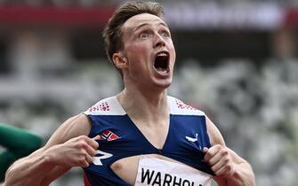 TOPSHOT - Norway's Karsten Warholm  reacts after winning and breaking the world record in the men's 400m hurdles final during the Tokyo 2020 Olympic Games at the Olympic Stadium in Tokyo on August 3, 2021. (Photo by Jewel SAMAD / AFP) (Photo by JEWEL SAMAD/AFP via Getty Images)