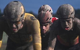 TOPSHOT - The pack rides during the 118th edition of the Paris-Roubaix one-day classic cycling race, between Compiegne and Roubaix, northern France, on October 3, 2021. (Photo by Anne-Christine POUJOULAT / AFP) (Photo by ANNE-CHRISTINE POUJOULAT/AFP via Getty Images)