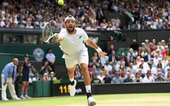 epaselect epa09337296 Matteo Berrettini of Italy in action against Novak Djokovic of Serbia during the men's final at the Wimbledon Championships, Wimbledon, Britain 11 July 2021.  EPA/NEIL HALL   EDITORIAL USE ONLY
