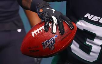 NEW YORK, NY - APRIL 04:  A general view of the 100 year logo on an NFL Football held by New York Jets safety Jamal Adams (33) as he models the New York Jets Stealth Black Uniform at the New York Jets New Uniform Unveiling on April 4, 2019 at Gotham Hall in New York, NY.  (Photo by Rich Graessle/Icon Sportswire via Getty Images)