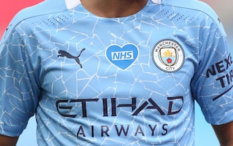 LONDON, ENGLAND - JULY 18: A detail view of an NHS logo displayed on a Manchester City shirt during the FA Cup Semi Final match between Arsenal and Manchester City at Wembley Stadium on July 18, 2020 in London, England. Football Stadiums around Europe remain empty due to the Coronavirus Pandemic as Government social distancing laws prohibit fans inside venues resulting in all fixtures being played behind closed doors. (Photo by Matt McNulty - Manchester City/Manchester City FC via Getty Images)