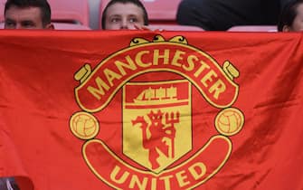 A boy displays a Manchester United flag prior to the UEFA Super Cup football match between Real Madrid and Manchester United on August 8, 2017, at the Philip II Arena in Skopje. / AFP PHOTO / ARMEND NIMANI        (Photo credit should read ARMEND NIMANI/AFP via Getty Images)