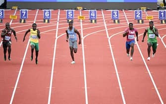 (From L) Kenya's Ferdinand Omanyala, Jamaica's Oblique Seville, Botswana's Letsile Tebogo, Italy's Lamont Marcell Jacobs empty lane, USA's Marvin Bracy and Nigeria's Favour Oghene Tejiri Ashe compete in the men's 100m semi-final during the World Athletics Championships at Hayward Field in Eugene, Oregon on July 16, 2022. - Olympic champion Marcell Jacobs withdrew from the 100m semi-finals at the World Athletics Championships due to a thigh injury, the Italian Athletics Federation (FIDAL) confirmed on Saturday. (Photo by Jim WATSON / AFP) (Photo by JIM WATSON/AFP via Getty Images)