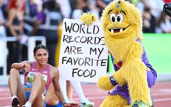 EUGENE, OREGON - JULY 22: Sydney McLaughlin of Team United States celebrates with Legend the mascot after winning gold and setting a new world record in the Women's 400m Hurdles Final on day eight of the World Athletics Championships Oregon22 at Hayward Field on July 22, 2022 in Eugene, Oregon. (Photo by Hannah Peters/Getty Images for World Athletics)
