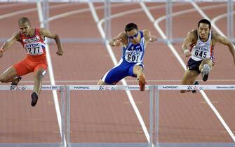 Winners of the men's 400m hurdles (L-R:) Felix Sanchez of the Dominican Republic, Fabrizio Mori of Italy and Dai Tamesue of Japan clear the hurdles during their race at the 8th World Championships in Athletics 10 August, 2001 at the  Commonwealth Stadium in Edmonton, Canada. Sanchez captured the gold in 47.49, Mori the silver (47.54) and Tamesue the bronze (47.89).   AFP PHOTO/John MABANGLO (Photo by JOHN G. MABANGLO / AFP)        (Photo credit should read JOHN G. MABANGLO/AFP via Getty Images)