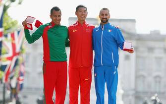 LONDON, ENGLAND - AUGUST 13:  Hao Wang of China, gold, poses with reallocated medal winners Eder Sanchez of Mexico, promoted from Bronze to Silver and Giorgio Rubino of Italy, promoted from fourth to Bronze, for the Men's 20 Kilometres Race Walk  during the 12th IAAF World Athletics Championships Berlin 2009 during day ten of the 16th IAAF World Athletics Championships London 2017 at The London Stadium on August 13, 2017 in London, United Kingdom.  (Photo by Michael Steele/Getty Images)