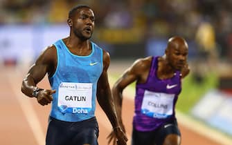DOHA, QATAR - MAY 15:  Justin Gatlin of the United States crosses the line to win the Men's 100m with Kim Collins of St Kitts and Nevis (R) finishing fourth during the Doha IAAF Diamond League 2015 meeting at the Qatar Sports Club on May 15, 2015 in Doha, Qatar.  (Photo by Francois Nel/Getty Images)