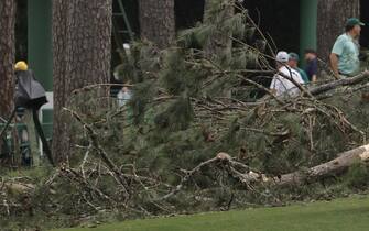 epa10564256 A large tree is on the ground near the 17th tee during a suspension in play due to weather, in the second round of the Masters Tournament at the Augusta National Golf Club in Augusta, Georgia, USA, 07 April 2023. The Augusta National Golf Club will hold the Masters Tournament from 06 April through 09 April 2023.  EPA/ERIK S. LESSER