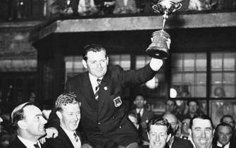(Original Caption) 10/7/1957-Lindrick, England: Welshman Dai Rees who served as Captain of the first victorius British Ryder Cup team since 1933 is shouldered by teammates as he holds aloft the coveted trophy. The British team scored a 7-4 win over America's professional golfers to take the cup.