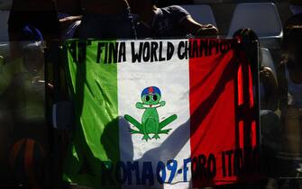 Italian fans hold a flag during the men's 200m individual medley qualifications on July 29, 2009 at the FINA World Swimming Championships in Rome. AFP PHOTO / FILIPPO MONTEFORTE (Photo credit should read FILIPPO MONTEFORTE/AFP via Getty Images)
