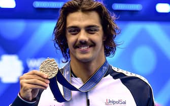 Gold medallist Italy's Thomas Ceccon poses after the medals ceremony for the men's 50m butterfly swimming event during the World Aquatics Championships in Fukuoka on July 24, 2023. (Photo by Yuichi YAMAZAKI / AFP) (Photo by YUICHI YAMAZAKI/AFP via Getty Images)