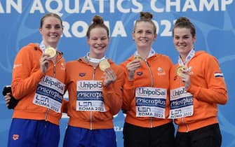 Members of The Netherlands' team celebrate on the podium with their Gold medal after winning the Women's 4 x 200m freestyle final event on August 11, 2022 during the LEN European Aquatics Championships in Rome. (Photo by Filippo MONTEFORTE / AFP) (Photo by FILIPPO MONTEFORTE/AFP via Getty Images)