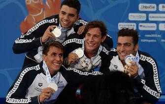 Members of Italy's team and Silver medallists pose on the podium after the Men's 4 x 200m freestyle final event on August 11, 2022 during the LEN European Aquatics Championships in Rome. (Photo by Filippo MONTEFORTE / AFP) (Photo by FILIPPO MONTEFORTE/AFP via Getty Images)