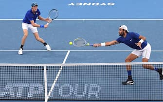 Italy's Matteo Berrettini and Jannik Sinner (L) return the ball to Russia's Daniil Medvedev and Roman Safiullin during their Group B men's doubles tennis match at the 2022 ATP Cup in Sydney on January 6, 2022. - -- IMAGE RESTRICTED TO EDITORIAL USE - STRICTLY NO COMMERCIAL USE -- (Photo by Muhammad FAROOQ / AFP) / -- IMAGE RESTRICTED TO EDITORIAL USE - STRICTLY NO COMMERCIAL USE -- (Photo by MUHAMMAD FAROOQ/AFP via Getty Images)