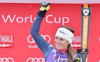 Italy's Nadia Fanchini celebrates on the podium after winning a women's Alpine ski downhill race, in La Thuile, Italy, Saturday, Feb. 20, 2016. ANSA/ANTONINO DI MARCO