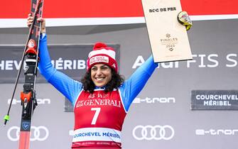 epa09838053 Winner Federica Brignone of Italy celebrates on the podium for the Women's Giant Slalom race at the FIS Alpine Skiing World Cup finals in Meribel, France, 20 March 2022.  EPA/URS FLUEELER
