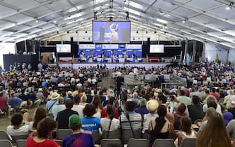 People attend the 18th edition of the World Sheep Shearing and Wool handling championships in Le Dorat, central-western France, on July 7, 2019. - From July 4 to 7, 2019 the competition takes place for the first time in France. More than 5,000 sheep will be shorn for four days during numerous competitions. (Photo by GEORGES GOBET / AFP)        (Photo credit should read GEORGES GOBET/AFP via Getty Images)