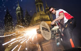epa05021417 A handout photograph made available on 12 November 2015 by Global Newsroom showing Arkadiusz Drozdek of Poland performing with his Hot Saw, a powerful 80 HP chain saw, in front of the Archcathedral Basilica of Saint Peter and Saint Paul prior to the Stihl Timbersports World Championships in Poznan, Poland, 11 November 2015.  EPA/SEBASTIAN MARKO / GLOBAL NEWSROOM  / HANDOUT  HANDOUT EDITORIAL USE ONLY/NO SALES