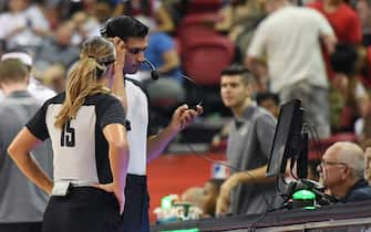 LAS VEGAS, NEVADA - JULY 06:  Green lights on the scorer's table are lit indicating a coach's challenge is under way as referees look at video during a game between the Los Angeles Lakers and the LA Clippers during the 2019 NBA Summer League at the Thomas & Mack Center on July 6, 2019 in Las Vegas, Nevada. The NBA is experimenting with adding a coach s challenge to the current replay review system. NOTE TO USER: User expressly acknowledges and agrees that, by downloading and or using this photograph, User is consenting to the terms and conditions of the Getty Images License Agreement.  (Photo by Ethan Miller/Getty Images)