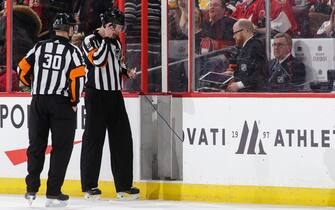 OTTAWA, ON - MARCH 9:  Referees Kendrick Nicholson #30 and Mike Hasenfratz #27 get ready to review a goal from a coach's challenge during a game between the Ottawa Senators and the Calgary Flames at Canadian Tire Centre on March 9, 2018 in Ottawa, Ontario, Canada.  (Photo by Jana Chytilova/Freestyle Photography/Getty Images) *** Local Caption ***