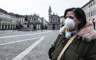 TURIN, ITALY - MARCH 16: A woman with a mask in Piazza San Carlo in Turin during on the Italy Continues Nationwide Lockdown To Control Coronavirus Spread on March 16, 2020 in Turin, Italy. Italian Government continues to enfoce the nationwide lockdown measures to control the coronavirus spread. (Photo by Stefano Guidi/Getty Images)