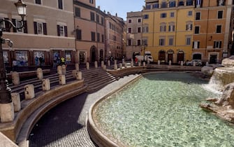 ROME, ITALY -  MARCH 11: The Trevi Fountain is closed for visitor on March 11, 2020 in Rome, Italy. The Italian Government has taken the unprecedented measure of a nationwide lockdown in an effort to fight the world's second-most deadly coronavirus (Covid-19) outbreak outside of China. The movements in and out are allowed only for work and health reasons proven by a medical certificate. The justifications for the movements needs to be certified with a self-declaration by filling in forms provided by the police forces in charge of the check. (Photo by Stefano Montesi - Corbis/ Getty Images)