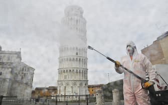PISA, ITALY - MARCH 17:  A worker carries out sanitation operations for the Coronavirus emergency in Piazza dei Miracoli near to the Tower of Pisa in a deserted town on March 17, 2020 in Pisa, Italy. The sanitization service is carried out by four teams in all the districts of the city of Pisa, to sanitize the squares, streets, public areas, sidewalks, surfaces exposed to the contact of large flows of people. Italian government has imposed unprecedented restrictions on its 60 million people as it expanded its emergency Coronavirus (Covid-19) lockdown nationwide. The number of confirmed Covid-19 cases in Italy has passed 31,500 with the death toll rising to 2503.  (Photo by Laura Lezza/Getty Images)