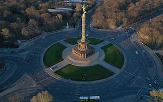 BERLIN, GERMANY - MARCH 23: (EDITOR'S NOTE: Photo taken with a drone.) In this aerial view the traffic circle at the Victory Column , which at rush hour is usually crowded with cars, stands nearly empty during the coronavirus crisis on March 23, 2020 in Berlin, Germany. The coronavirus and the disease it causes, COVID-19, are having a fundamental impact on society, government and the economy in Germany. Public life has been restricted to the essentials in an effort by authorities to slow the spread of infections. Hospitals are scrambling to increase their testing and care capacity. An economic recession seems likely as economic activity is slowed and many businesses are temporarily closed. Schools, daycare centers and universities remain shuttered. And government, both federal and state, seek to mobilize resources and find adequate policies to confront the virus and mitigate its impact. (Photo by Sean Gallup/Getty Images)