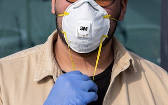 CASALPUSTERLENGO, ITALY - FEBRUARY 23: A man wearinig a respiratory mask and gloves is pictured on February 23, 2020 in Casalpusterlengo, south-west Milan, Italy. Casalpusterlengo is one of the ten small towns placed under lockdown earlier this morning as a second death from coronavirus sparked fears throughout the Lombardy region. (Photo by Emanuele Cremaschi/Getty Images)