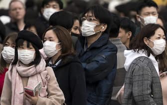 TOKYO, JAPAN - FEBRUARY 02: People wearing masks wait to cross a road  in the Shibuya district on February 02, 2020 in Tokyo, Japan. Japan reported 20 cases of Wuhan coronavirus infections as the number of those who have died from the virus, known as 2019-nCoV, in China climbed to over 300 and cases have been reported in other countries including the United States, Canada, Australia, Japan, South Korea, India, the United Kingdom, Germany, France, and several others.  (Photo by Tomohiro Ohsumi/Getty Images)