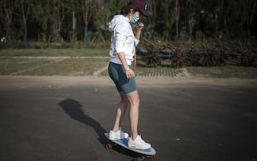 WUHAN, CHINA - APRIL 13: A woman skateboards in Jiangtan Park on April 13, 2020 in Wuhan, Hubei Province, China. Despite the partial lift of the 76 day long lockdown, Wuhan's residential communities are still strictly controlling the flow of people. (Photo by Getty Images)