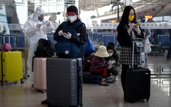 Passengers wearing face masks wait at the Wuhan railway station in Wuhan in China's central Hubei province early on April 15, 2020. (Photo by NOEL CELIS / AFP) (Photo by NOEL CELIS/AFP via Getty Images)