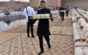 epa07536841 Waiters carry cocktails for guests ahead of the presentation of the Dior Cruise collection 2020 by Italian designer Maria Grazia Chiuri in Marrakech, Morocco, 29 April 2019.  EPA/JALAL MORCHIDI