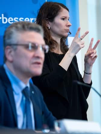 German Robert Koch-Institute, Lothar H. Wieler speaks next to a sign language interpreter (R) during a press conference on the spread of the novel coronavirus in Germany on March 23, 2020 in Berlin. - Chancellor Angela Merkel announced on March 22, 2020 a ban on public gatherings of more than two people and further infection control measures. (Photo by Bernd von Jutrczenka / POOL / AFP) (Photo by BERND VON JUTRCZENKA/POOL/AFP via Getty Images)