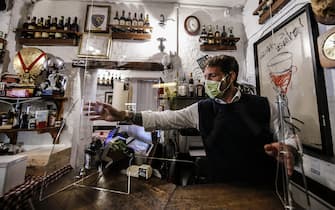 Giorgio Viscione, from Nuova Gigaprint company, delivers some plexiglass separators to carry out a test in a typical Italian restaurant ''Il Ciak'', at Trastevere district in Rome, Italy, 23 April 2020. Countries around the world are taking measures to stem the widespread of the SARS-CoV-2 coronavirus which causes the Covid-19 disease. ANSA / FABIO FRUSTACI