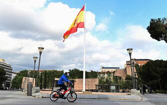 epa08387781 A child wearing a protective face mask rides his bike on Columbus Square, in Madrid, Spain, 27 April 2020, on the second day minors are allowed an hour-a-day walk since lockdown was ordered in Spain 44 days ago in an attempt to flatten the coronavirus curve.  EPA/Fernando Villar
