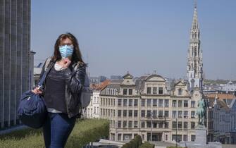 epa08372896 A woman wearing a face mask in the city center of Brussels, Belgium, 20 April 2020. In order to contain the spread of the coronavirus Sars-CoV-2, Belgium is implementing confinement guidelines for the public which is scheduled to be in place until 03 May 2020. Only supermarkets and essential trade will remain open. Countries around the world are taking increased measures to stem the further spread of the SARS-CoV-2 coronavirus which causes the Covid-19 disease.  EPA/OLIVIER HOSLET