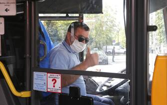 epa08386813 A public bus driver wears a protective face mask, in Zagreb, Croatia, 27 April 2020. According to media reports, Croatia is easing the restrictive measures to prevent the spread of the SARS-CoV-2 coronavirus which causes the COVID-19 disease, by lifting the ban on public transport and reopening cultural institutions, libraries and stores on 27 April 2020.  EPA/ANTONIO BAT
