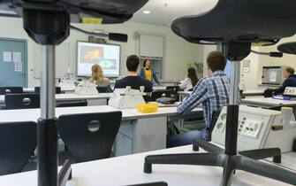 Teacher Anna Boehm talks to her chemistry class at the Friedrich-Schiller-Gymnasium (Friedrich-Schiller high school) in Ludwigsburg, southern Germany, on May 4, 2020, amid the novel coronavirus COVID-19 pandemic. - Schools in the federal state of Baden-Wuerttemberg re-opended on May 4, 2020 for graduating classes under strict rules for hygiene and social distancing. (Photo by THOMAS KIENZLE / AFP) (Photo by THOMAS KIENZLE/AFP via Getty Images)