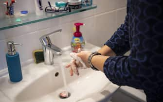 epa08408642 Midwife Alexandra washes her hands during a postpartum care at a Family in Munich, Bavaria, Germany, 07 May 2020. The midwives of the birth centre in Munich have adapted their postpartum care to the current circumstances due to the Coronavirus pandemic. As far as possible, more distance is kept from the mothers, and no conversations are held during the examinations. Regular hand washing or disinfection is part of the routine.  EPA/LUKAS BARTH-TUTTAS