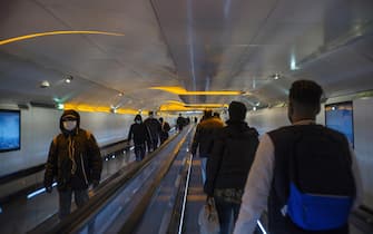 epa08413894 Commuters wearing face masks walk in a tunnel of a subway metro station in Paris, France, 11 May 2020. France began a gradual easing of its lockdown measures and restrictions amid the COVID-19 pandemic.  EPA/JULIEN DE ROSA